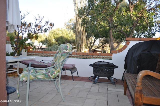 view of patio featuring area for grilling and a fire pit