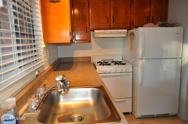 kitchen with white appliances and sink