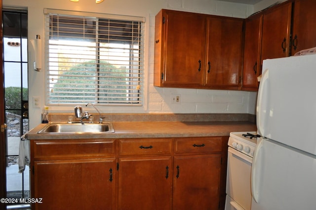 kitchen featuring sink and white appliances