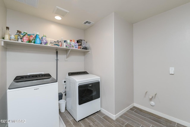 washroom with hardwood / wood-style floors and independent washer and dryer