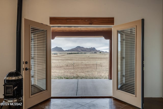 doorway to outside with tile patterned flooring, a mountain view, and french doors