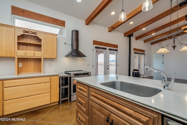 kitchen featuring pendant lighting, beamed ceiling, stainless steel stove, and exhaust hood