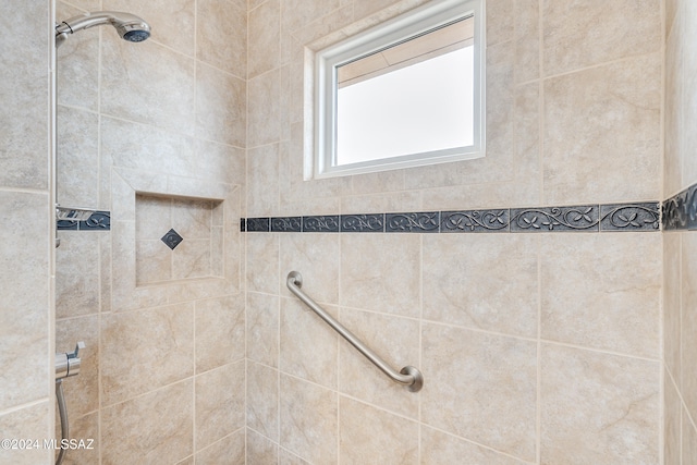 bathroom with tiled shower