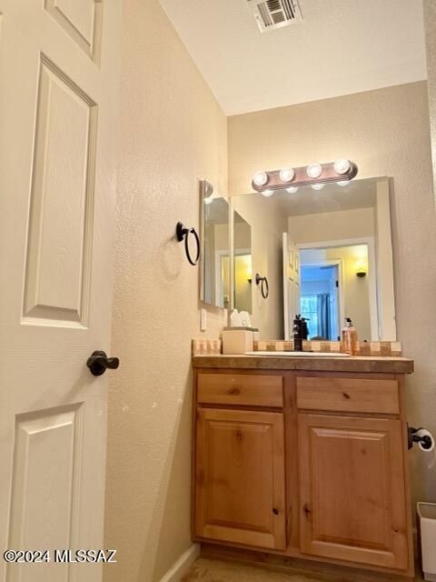 bathroom featuring vanity and vaulted ceiling