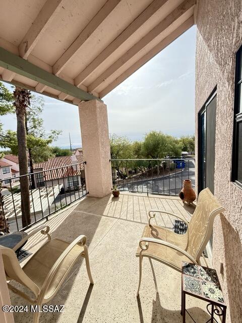 view of patio featuring a balcony