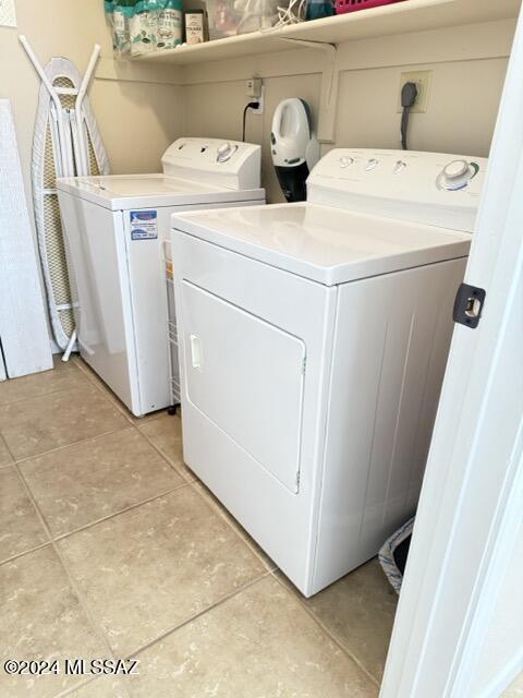 washroom featuring washing machine and clothes dryer and light tile patterned floors