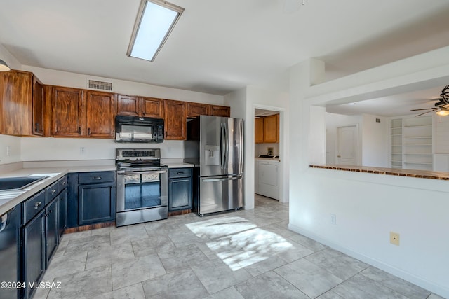 kitchen with black appliances, ceiling fan, washer / dryer, and sink