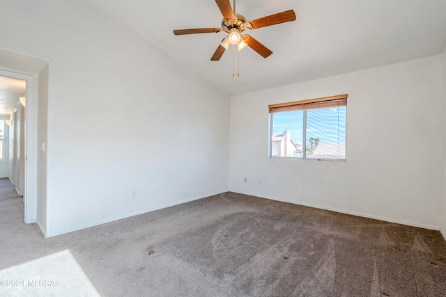 carpeted empty room with ceiling fan and vaulted ceiling