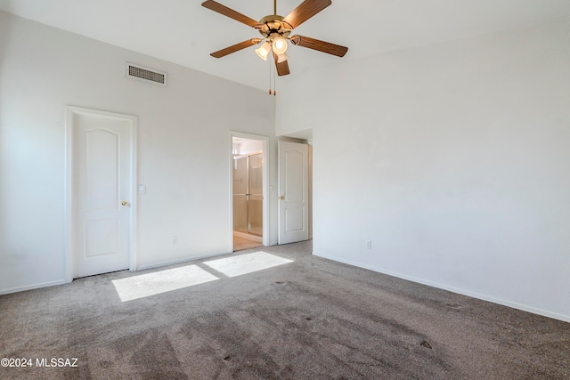 unfurnished bedroom featuring light carpet, connected bathroom, and ceiling fan