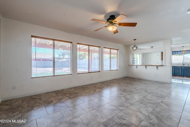 unfurnished living room featuring ceiling fan