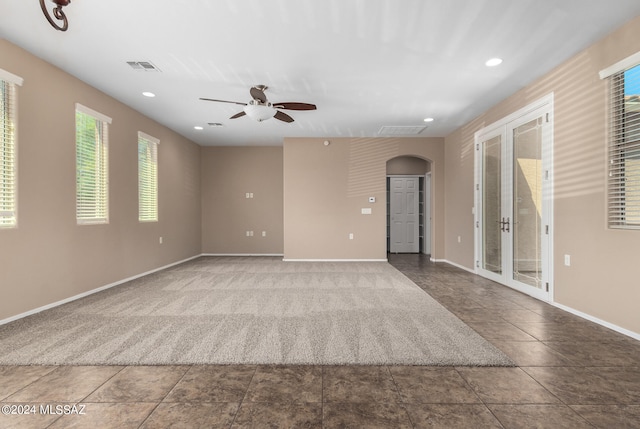 unfurnished room featuring ceiling fan and french doors