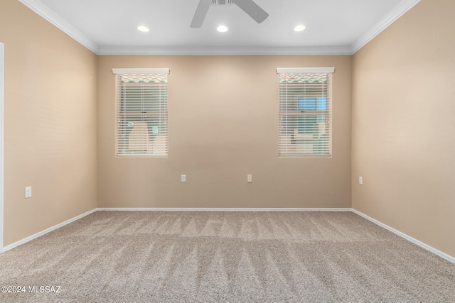 carpeted empty room featuring ceiling fan and crown molding