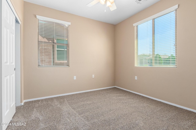 empty room featuring ceiling fan and carpet floors