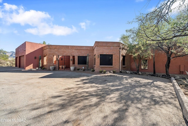 back of house featuring a garage