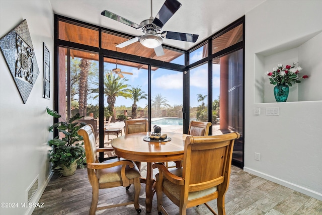 dining area with a wealth of natural light, hardwood / wood-style floors, and ceiling fan