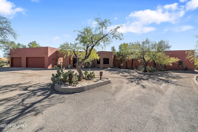 pueblo-style home with a garage