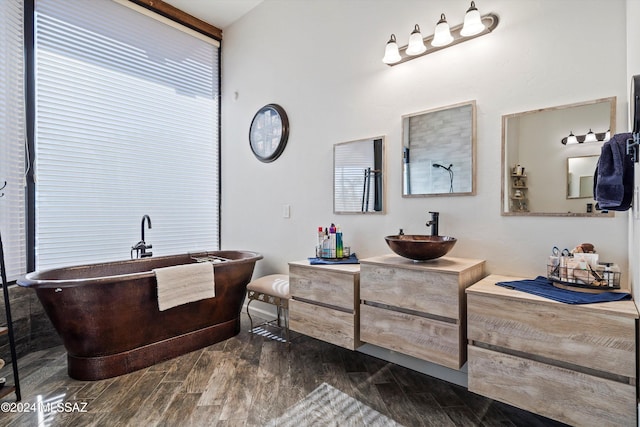 bathroom featuring a bathing tub, vanity, and hardwood / wood-style flooring