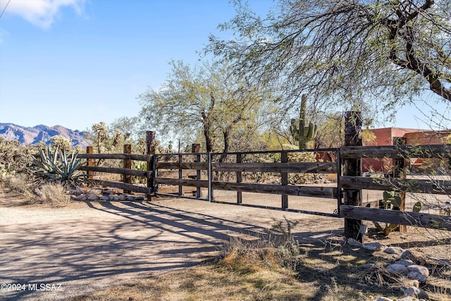 view of gate with a mountain view and a rural view