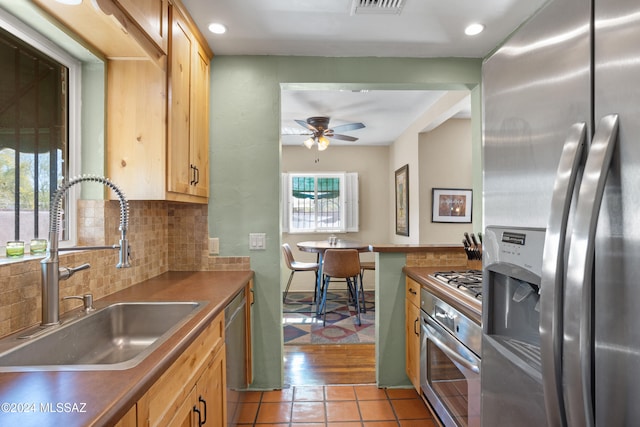 kitchen featuring a healthy amount of sunlight, sink, stainless steel appliances, and light wood-type flooring