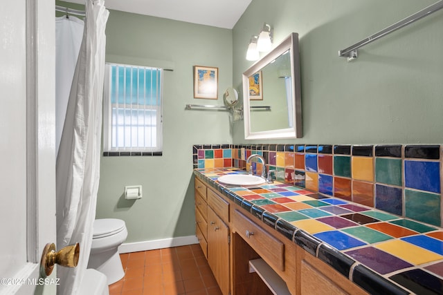 bathroom featuring backsplash, tile patterned floors, vanity, and toilet