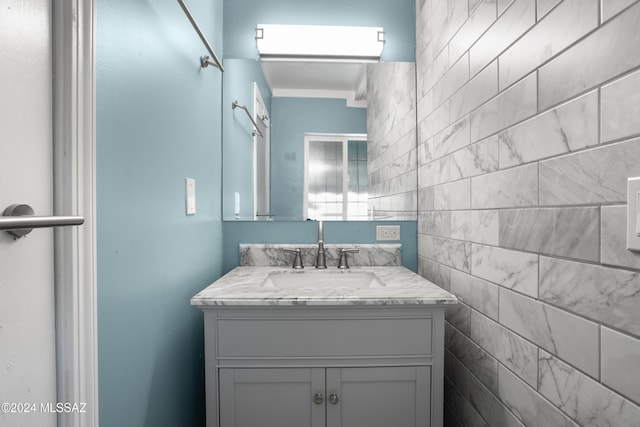 bathroom featuring vanity and tile walls