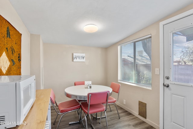 dining space featuring wood-type flooring