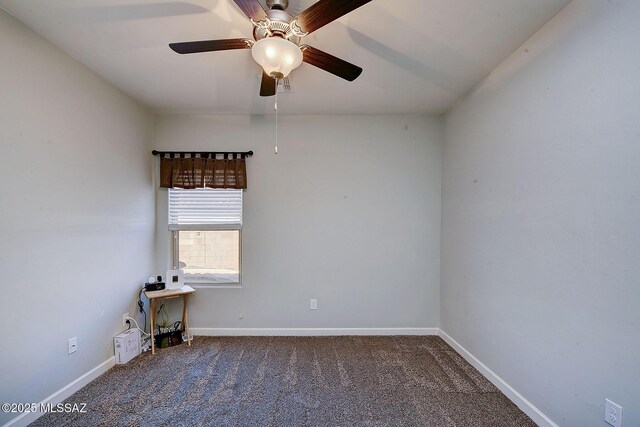 spare room featuring ceiling fan, carpet floors, and baseboards