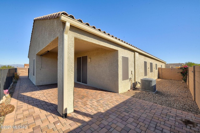 back of property featuring cooling unit and a patio area