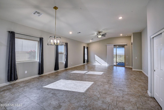 unfurnished room with ceiling fan with notable chandelier and lofted ceiling