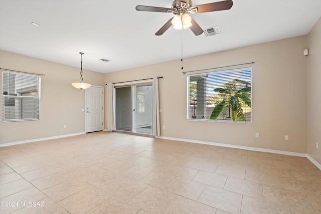 empty room featuring ceiling fan and light tile patterned flooring