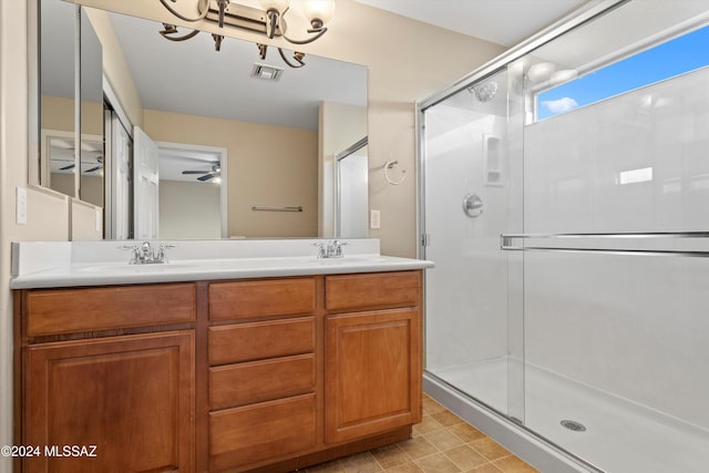 bathroom with vanity, a shower with shower door, and ceiling fan with notable chandelier