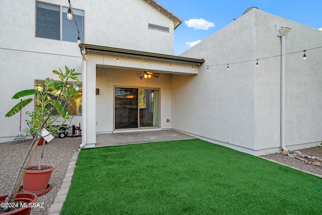 back of property with a patio area, ceiling fan, and a yard