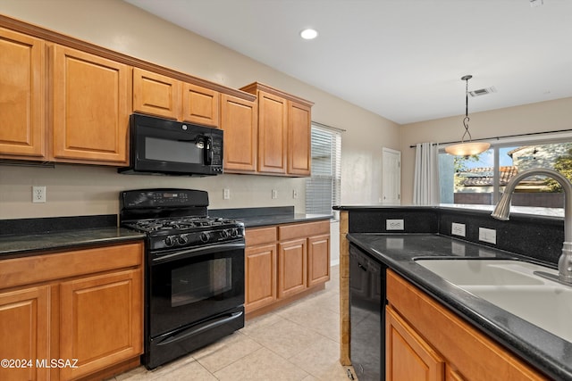 kitchen with black appliances, pendant lighting, light tile patterned floors, and sink