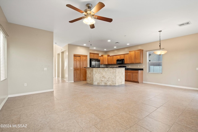 kitchen with hanging light fixtures, ceiling fan, stainless steel fridge, light tile patterned floors, and a kitchen island