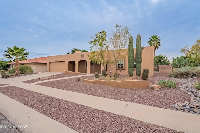 1349 N Paseo De Golf, Green Valley, AZ 85614 - pueblo revival-style home featuring a garage, driveway, stucco siding, and fence