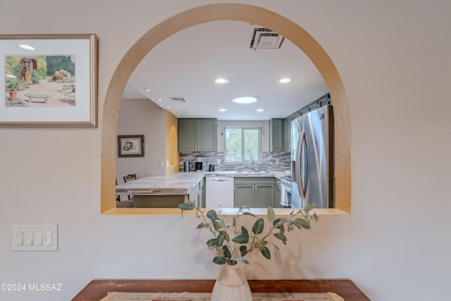 kitchen featuring tasteful backsplash, sink, and appliances with stainless steel finishes