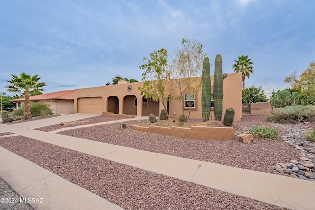 pueblo-style house with a garage