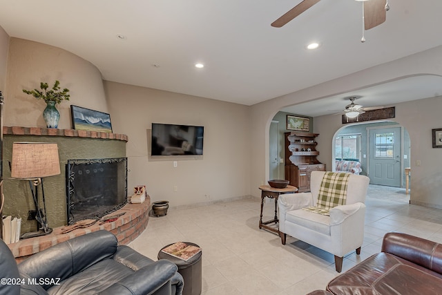 1349 N Paseo De Golf, Green Valley, AZ 85614 - living area featuring arched walkways, ceiling fan, a fireplace, baseboards, and recessed lighting