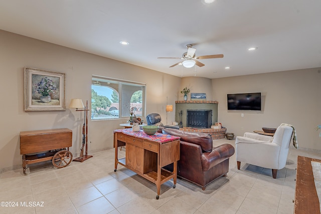 living room with ceiling fan, a fireplace, and light tile patterned flooring