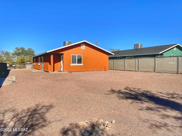 rear view of property featuring central air condition unit