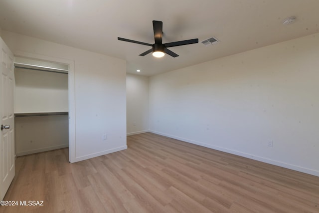 unfurnished bedroom featuring light wood-type flooring, a closet, and ceiling fan