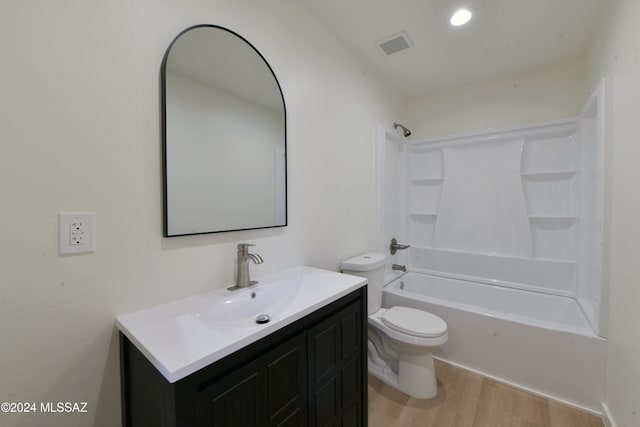 full bathroom featuring hardwood / wood-style flooring, vanity, toilet, and bathtub / shower combination