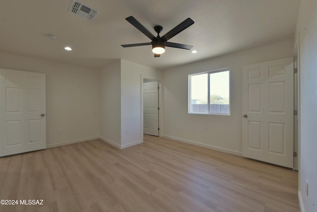 unfurnished bedroom with ceiling fan and light hardwood / wood-style flooring