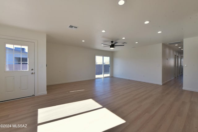 unfurnished living room featuring ceiling fan and wood-type flooring