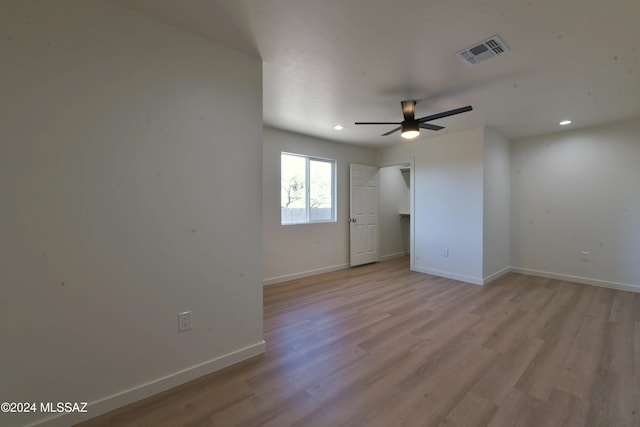 empty room with light hardwood / wood-style floors and ceiling fan