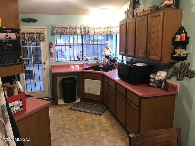 kitchen with a textured ceiling and sink