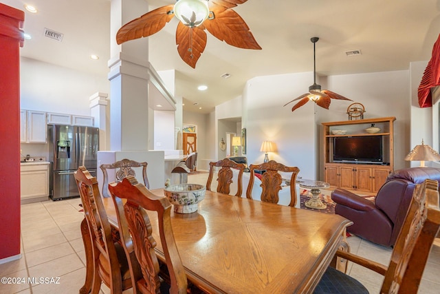 dining space with light tile patterned floors, decorative columns, and lofted ceiling