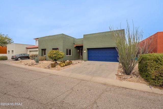 pueblo-style house with a garage