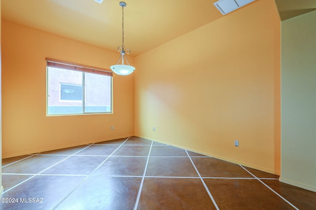 unfurnished room featuring dark tile patterned flooring