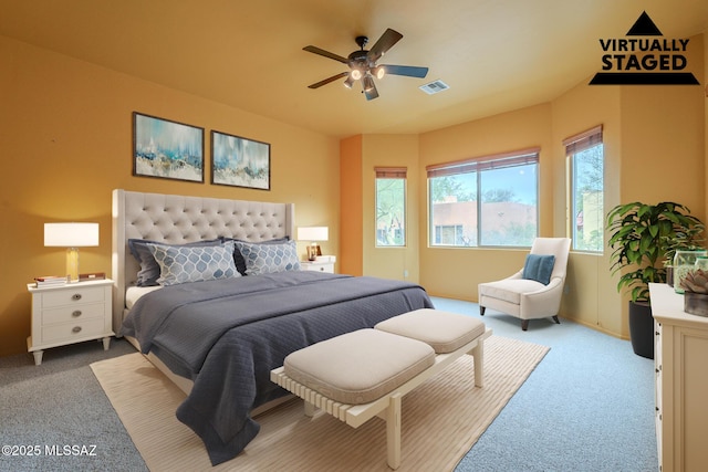 bedroom with ceiling fan and light carpet